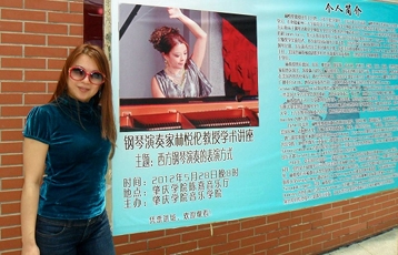 Helen in front of her Concert banner -- the colors sizzle!